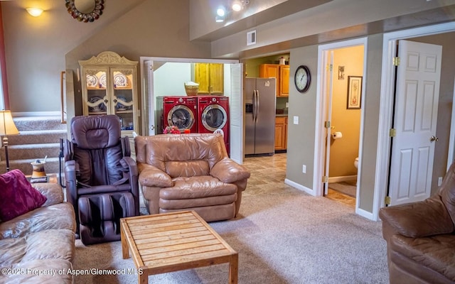 337 E 5 Th St, Rifle, CO 81650 - living area featuring light carpet, washing machine and clothes dryer, and lofted ceiling