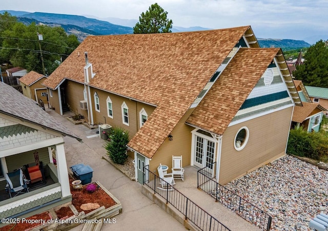 337 E 5 Th St, Rifle, CO 81650 - view of home's exterior featuring a mountain view, roof with shingles, french doors, and a patio area