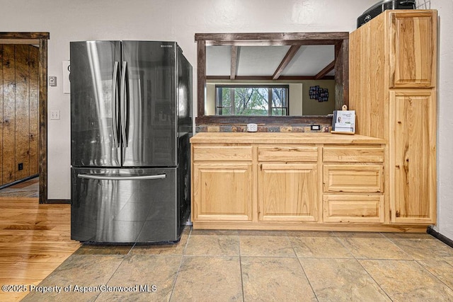 3598 County Road 35, Craig, CO 81625 - kitchen with freestanding refrigerator, light brown cabinets, baseboards, and beam ceiling