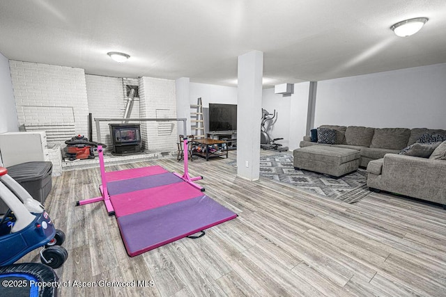 3598 County Road 35, Craig, CO 81625 - exercise area featuring a wood stove and wood finished floors