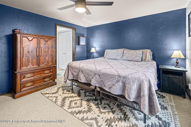 3598 County Road 35, Craig, CO 81625 - bedroom featuring a textured wall, light colored carpet, a closet, ceiling fan, and baseboards