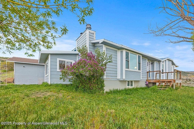 3598 County Road 35, Craig, CO 81625 - view of side of home with a chimney and a yard