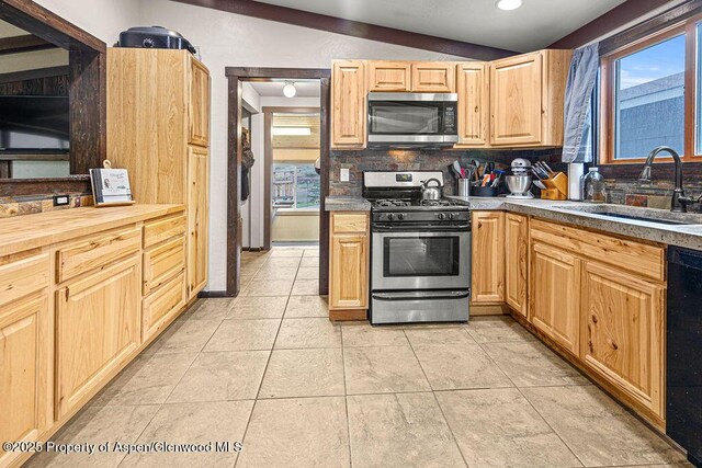 3598 County Road 35, Craig, CO 81625 - kitchen featuring stainless steel appliances, a sink, tasteful backsplash, light tile patterned floors, and light brown cabinets