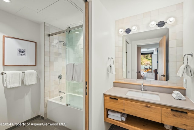 bathroom featuring vanity and enclosed tub / shower combo