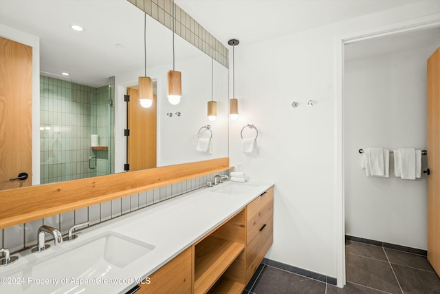 bathroom with tile patterned floors, vanity, and an enclosed shower