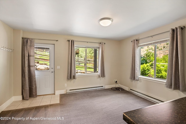 interior space featuring a wealth of natural light, light tile patterned floors, and a baseboard radiator