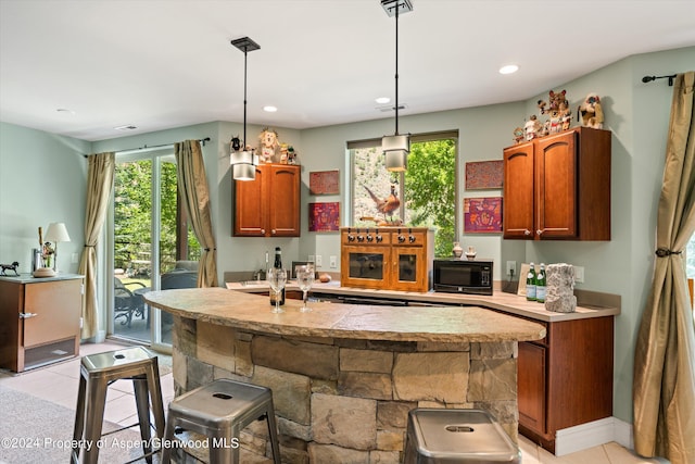 kitchen with a breakfast bar and decorative light fixtures