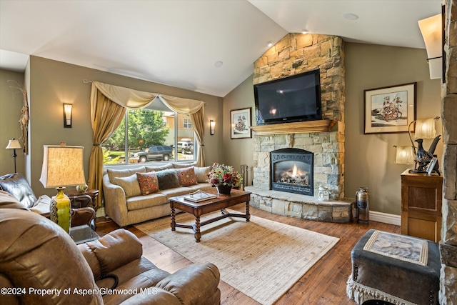 living room featuring wood-type flooring, a fireplace, and vaulted ceiling