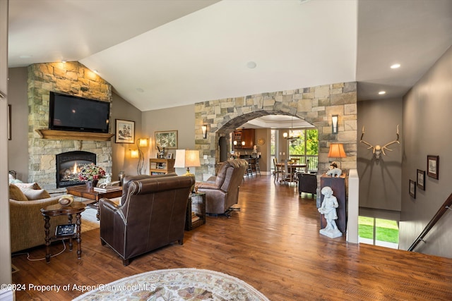 living room with hardwood / wood-style flooring, a fireplace, and vaulted ceiling