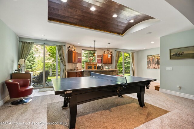 playroom featuring a raised ceiling, light carpet, wooden ceiling, and indoor bar