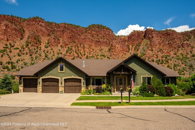 view of front facade with a mountain view and a garage