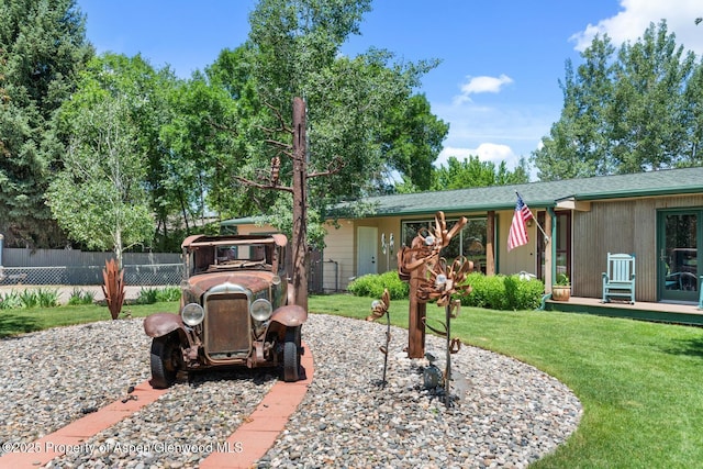 exterior space with a lawn and fence