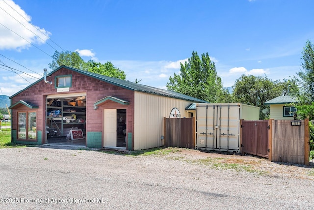 exterior space with an outbuilding and fence