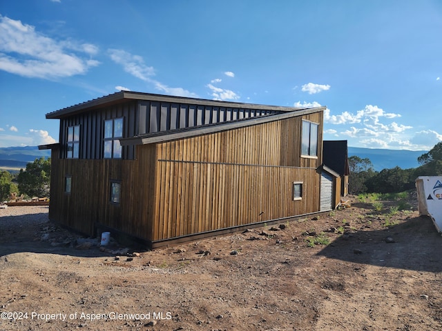 view of side of property with a mountain view