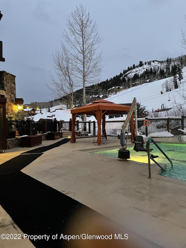 view of home's community featuring a gazebo, a patio area, and a mountain view