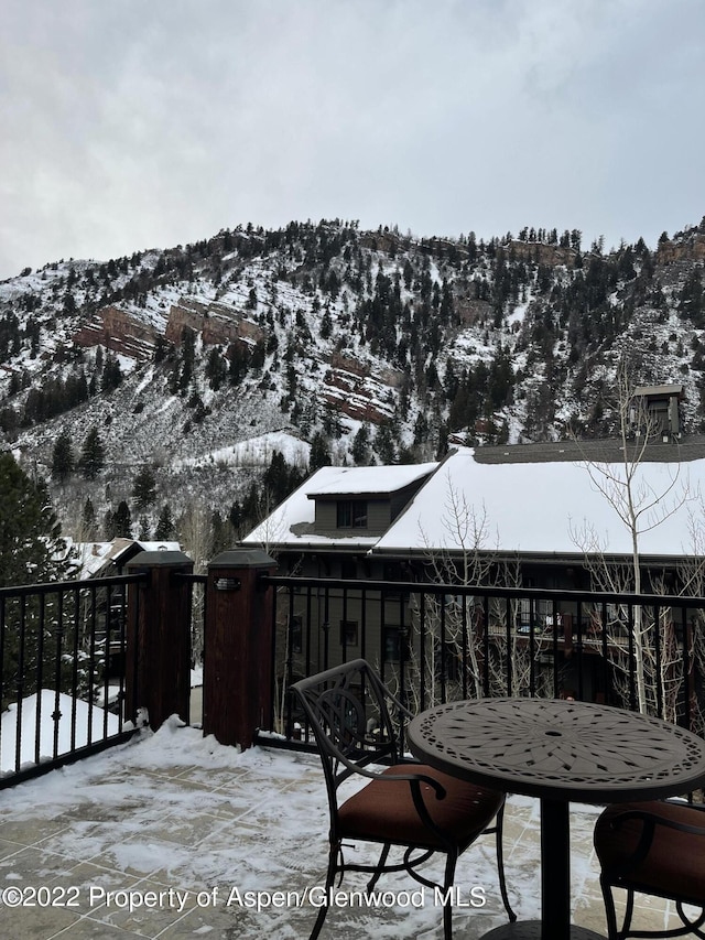 snow covered deck featuring a mountain view