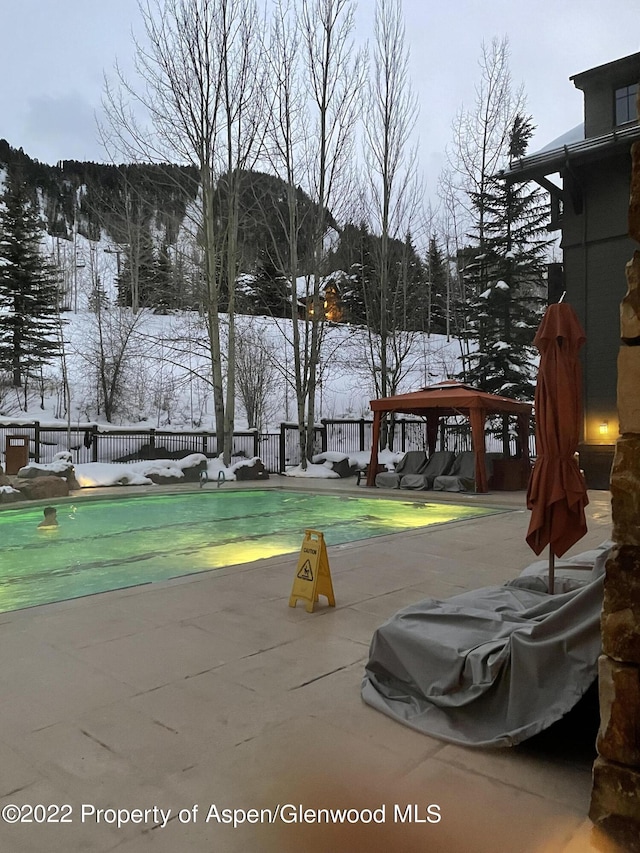 exterior space featuring a gazebo, a swimming pool, and a patio