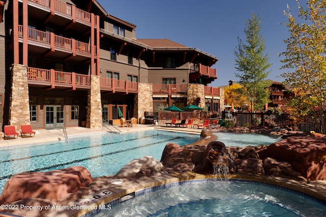 view of pool with pool water feature