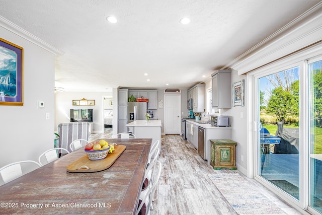 10155 6400th Rd, Montrose, CO 81401 - dining space with recessed lighting, crown molding, light wood-style flooring, and a textured ceiling