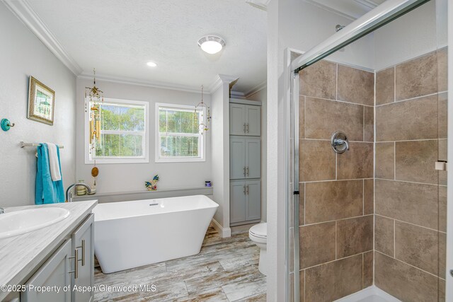 10155 6400th Rd, Montrose, CO 81401 - full bath with crown molding, a stall shower, vanity, a textured ceiling, and a freestanding tub