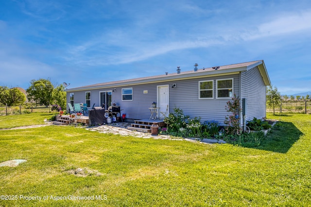 10155 6400th Rd, Montrose, CO 81401 - rear view of property with a deck and a lawn