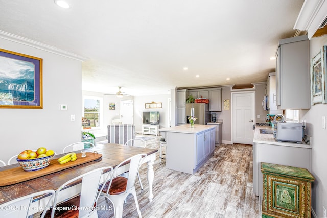 10155 6400th Rd, Montrose, CO 81401 - kitchen with a kitchen island, light countertops, light wood-type flooring, gray cabinets, and freestanding refrigerator