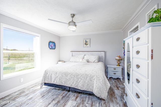 10155 6400th Rd, Montrose, CO 81401 - bedroom featuring a textured ceiling, ceiling fan, wood finished floors, baseboards, and ornamental molding