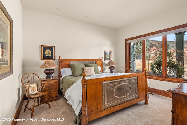 bedroom with visible vents, baseboards, and light carpet