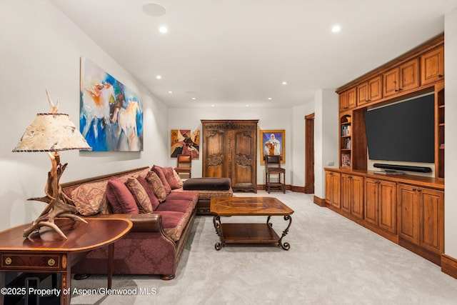 living area with recessed lighting, baseboards, and light colored carpet