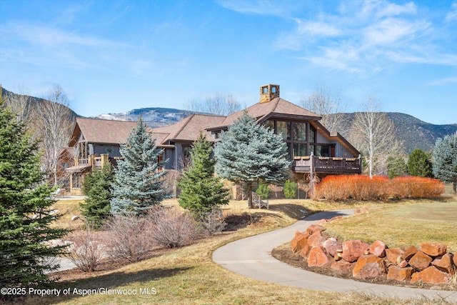 surrounding community featuring a lawn and a mountain view