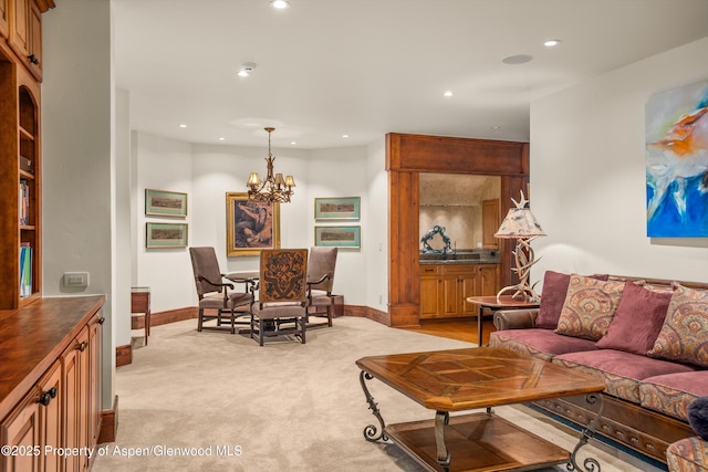 living room featuring light carpet, a notable chandelier, recessed lighting, and baseboards