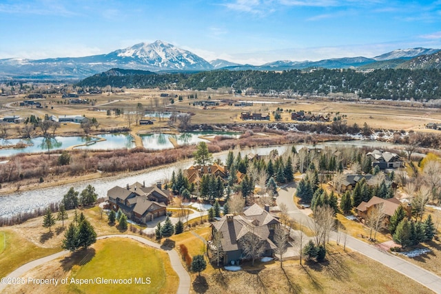 aerial view featuring a water and mountain view