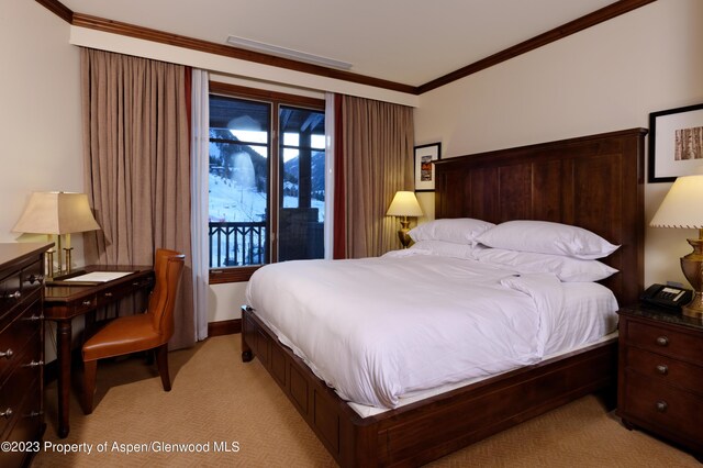 carpeted bedroom featuring ornamental molding and access to outside