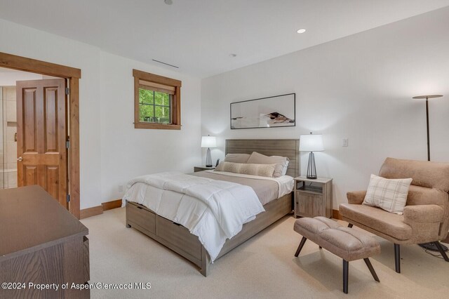 bedroom with light colored carpet