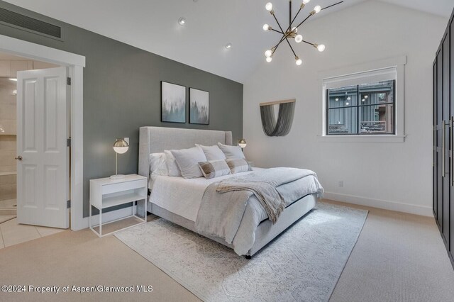 bedroom featuring light colored carpet, lofted ceiling, and a notable chandelier