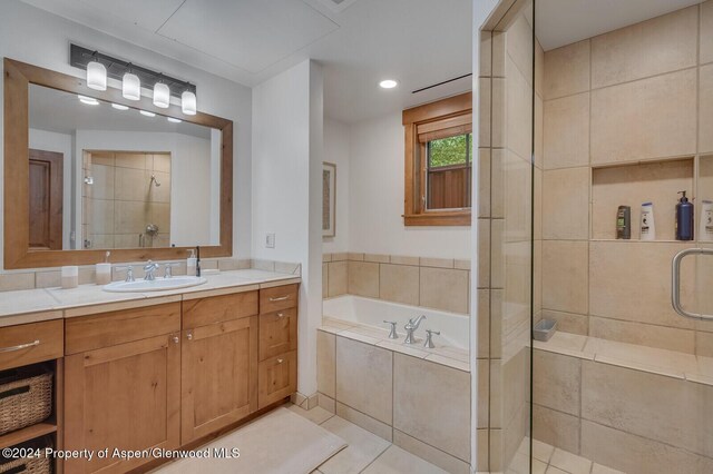 106 Clubhouse Dr Unit 180, Snowmass Village, CO 81615 - bathroom featuring vanity, tile patterned flooring, and plus walk in shower