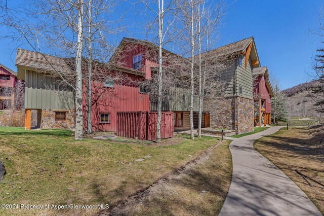 106 Clubhouse Dr Unit 180, Snowmass Village, CO 81615 - view of property exterior with a yard