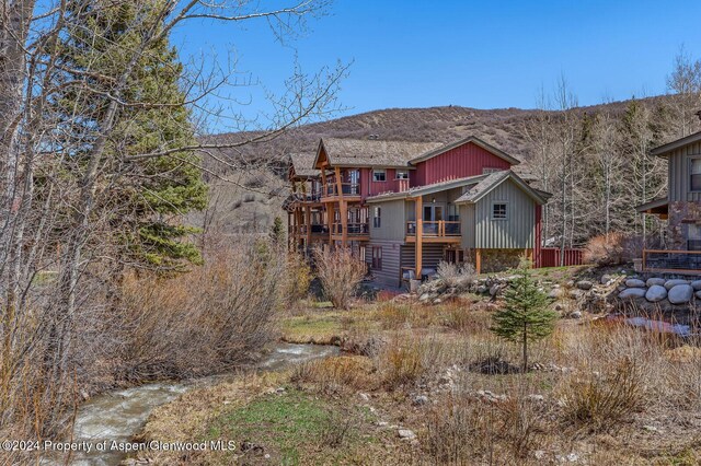 back of house with a mountain view