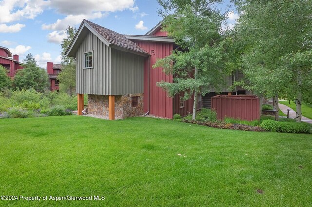 view of property exterior featuring a lawn