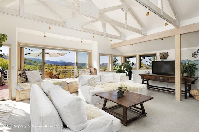 living area with beamed ceiling and high vaulted ceiling