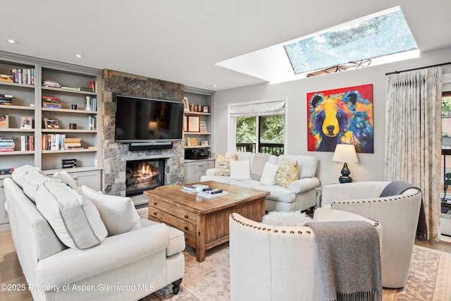 650 S Monarch St Unit 10, Aspen, CO 81612 - living area with a skylight, a stone fireplace, recessed lighting, and light wood-type flooring