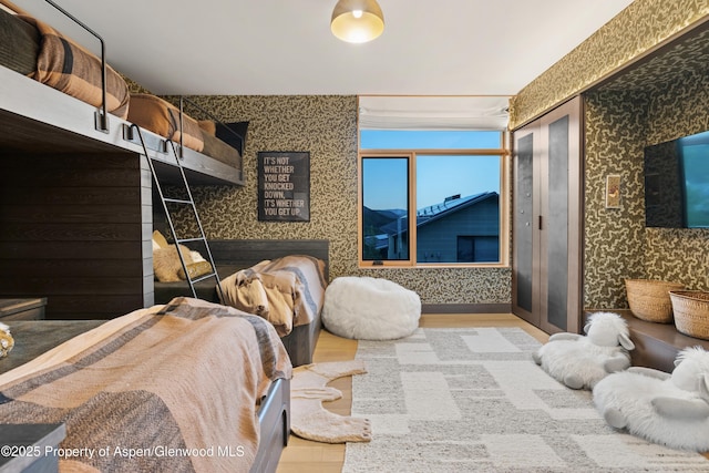 411 Wood Rd Unit 10, Snowmass Village, CO 81615 - bedroom featuring wallpapered walls and wood finished floors