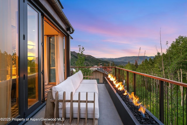 411 Wood Rd Unit 10, Snowmass Village, CO 81615 - balcony at dusk featuring a mountain view