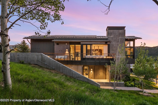 411 Wood Rd Unit 10, Snowmass Village, CO 81615 - back of house at dusk with a balcony