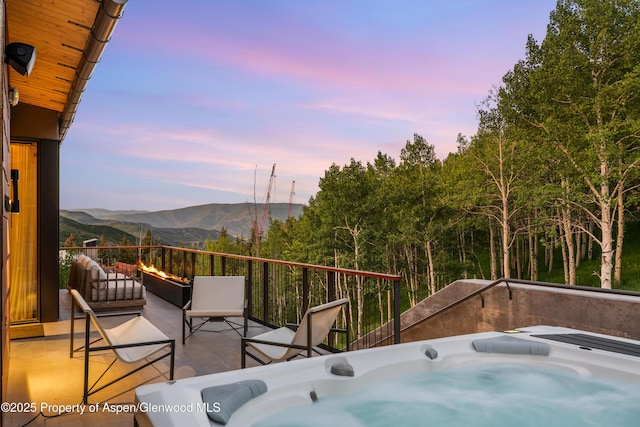 411 Wood Rd Unit 10, Snowmass Village, CO 81615 - view of patio featuring a hot tub and a mountain view