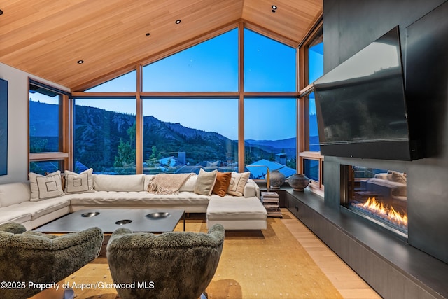 411 Wood Rd Unit 10, Snowmass Village, CO 81615 - living area featuring a premium fireplace, lofted ceiling, wood finished floors, expansive windows, and wood ceiling