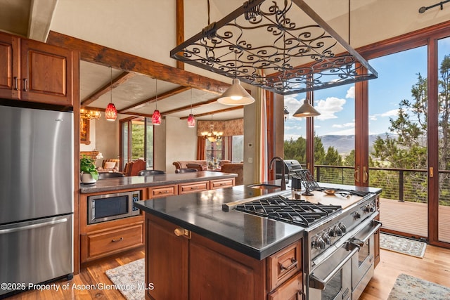 845 Hillcrest Dr, Basalt, CO 81621 - kitchen featuring appliances with stainless steel finishes, a chandelier, light wood-type flooring, brown cabinetry, and beam ceiling
