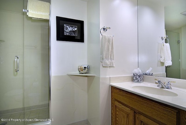 bathroom featuring a stall shower and vanity