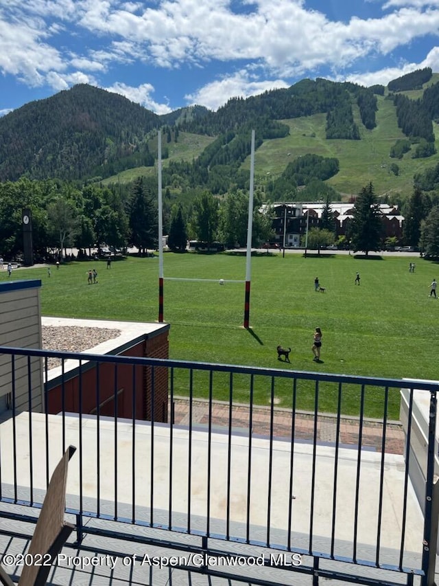 surrounding community featuring a mountain view and a lawn