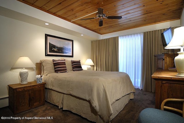 bedroom with a tray ceiling, a ceiling fan, wood ceiling, and carpet flooring